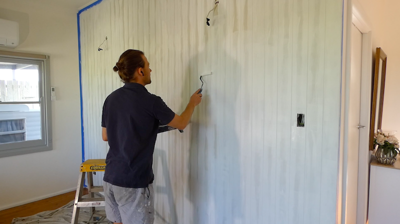 Use a roller to paint the wood panels