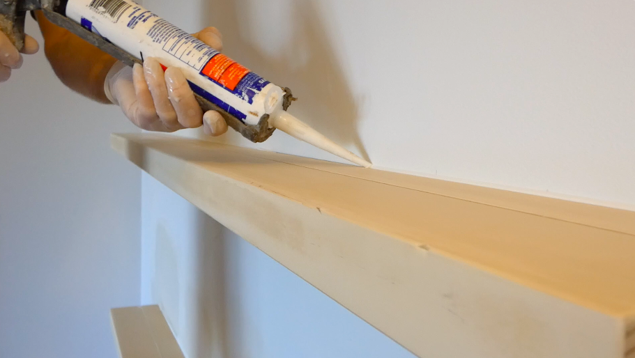 Caulking the gap between the shelf and the wall