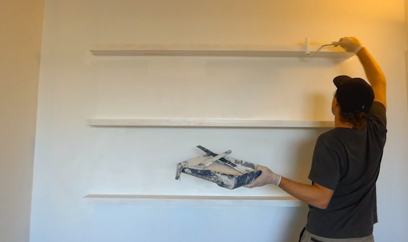 Paint the wooden shelves with a roller